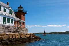 Sailboat by Rockland Breakwater Light on a Summer Day